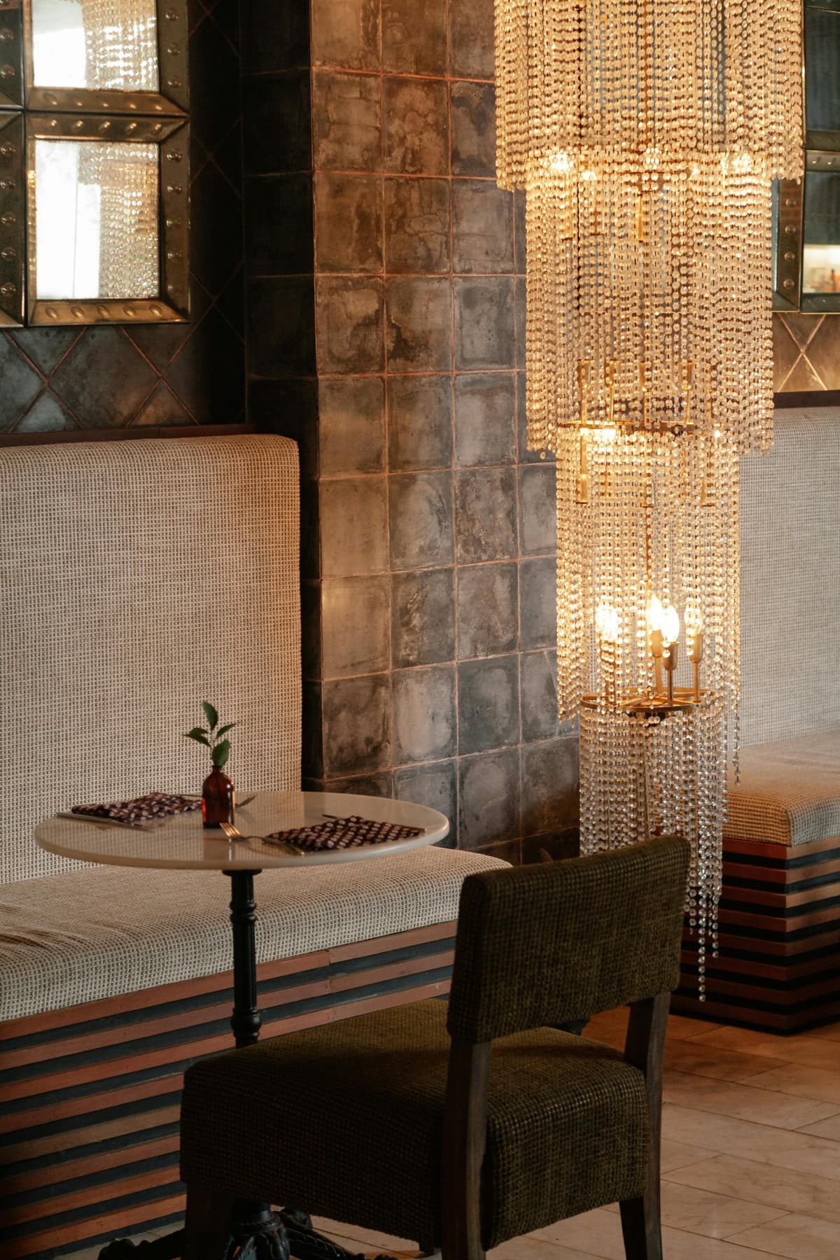 A tailored banquette setting with warm lighting and upholstered bench seating.